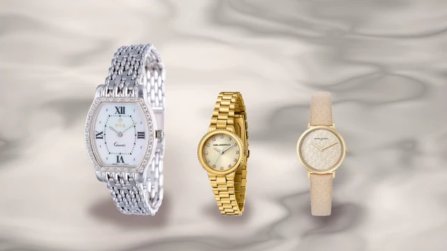Ceas de dama din aur de 14K alaturi de doua ceasuri aurii placate, pe fundal de marmura